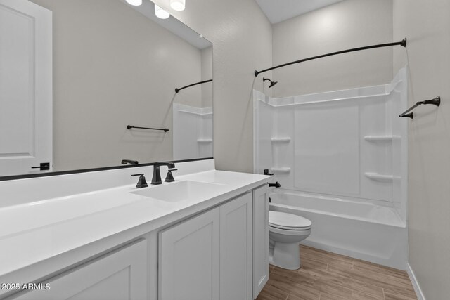 12316 W Parkway Ln, Avondale, AZ 85323 - bathroom featuring toilet, wood finished floors, vanity, shower / bath combination, and baseboards