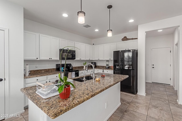 kitchen featuring sink, black appliances, white cabinets, and a center island with sink