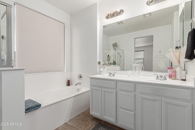 bathroom featuring independent shower and bath and vanity