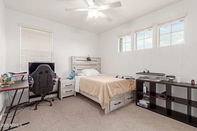 bedroom featuring ceiling fan and light carpet