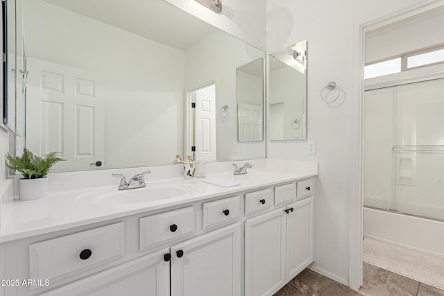 bathroom with vanity and bath / shower combo with glass door