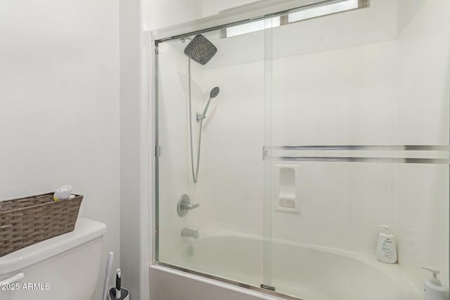 bathroom featuring enclosed tub / shower combo and toilet