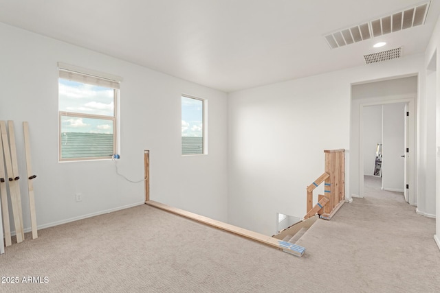 unfurnished room with light carpet