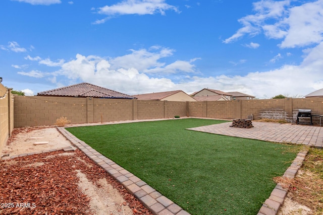 view of yard with a fire pit and a patio area