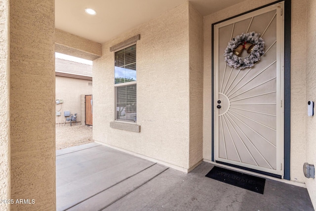 property entrance featuring a patio area