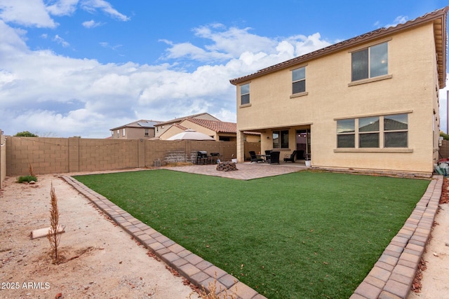 rear view of property with a patio and a lawn