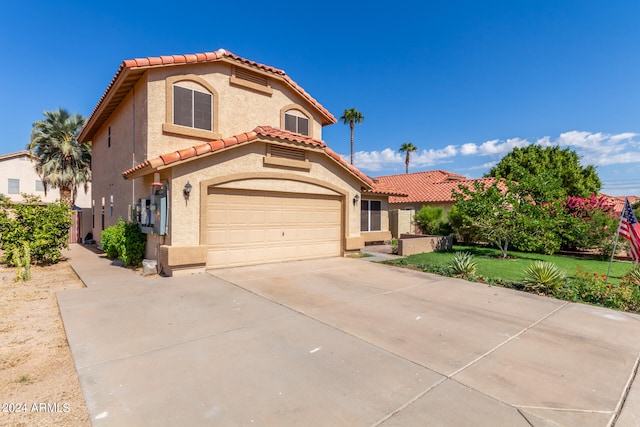 mediterranean / spanish-style house with a garage