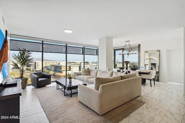 living room with a wall of windows and an inviting chandelier