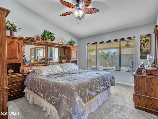 carpeted bedroom with ceiling fan and vaulted ceiling