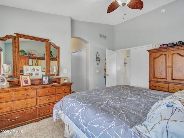 carpeted bedroom featuring vaulted ceiling and ceiling fan