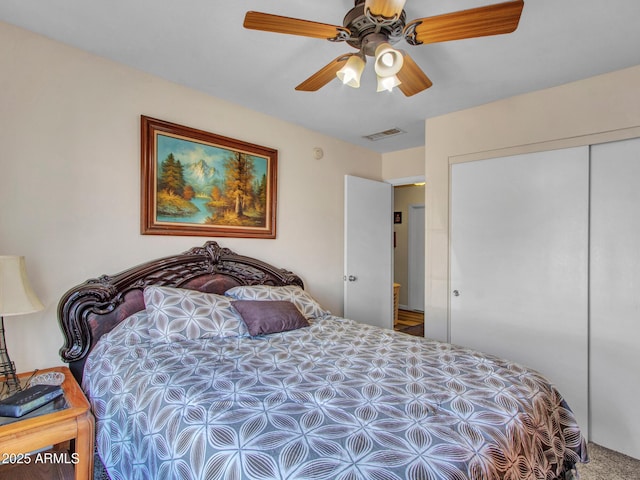 carpeted bedroom featuring ceiling fan and a closet