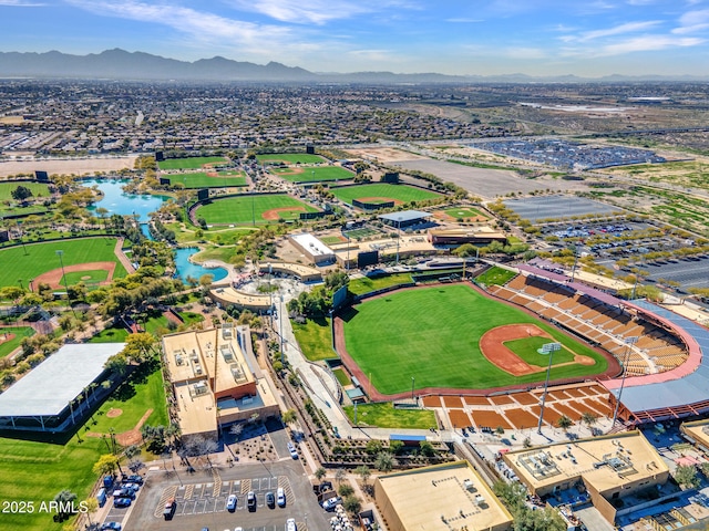 drone / aerial view featuring a water and mountain view