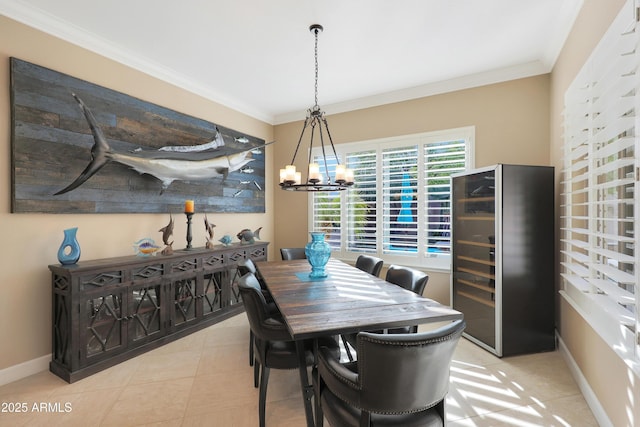 dining space with a chandelier, wine cooler, baseboards, and crown molding