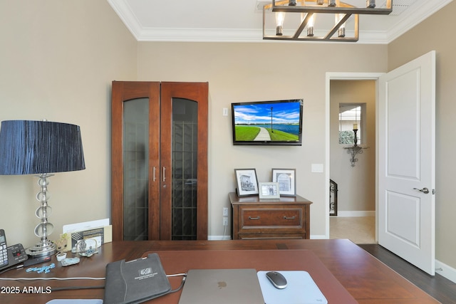 office space with ornamental molding, dark wood-style flooring, and baseboards