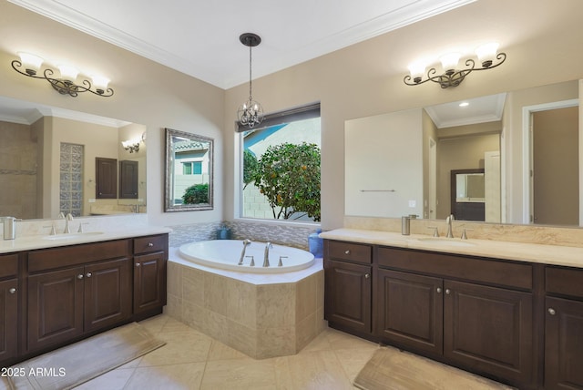 bathroom featuring a garden tub, two vanities, a sink, and crown molding