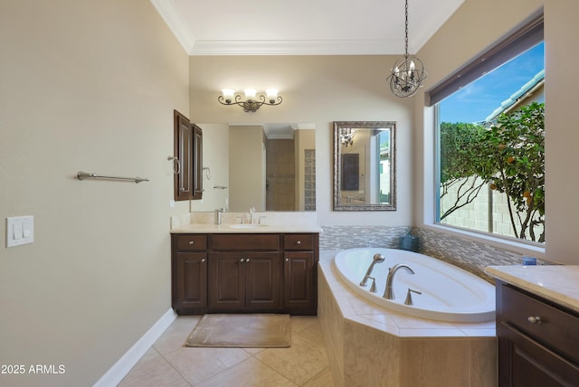 bathroom with tile patterned floors, an inviting chandelier, crown molding, vanity, and a bath