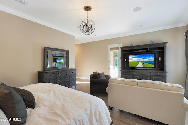 bedroom with crown molding, dark wood-style flooring, visible vents, baseboards, and an inviting chandelier