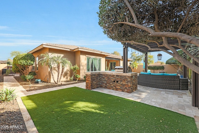 view of yard featuring exterior kitchen, a patio area, fence, and an outdoor hangout area