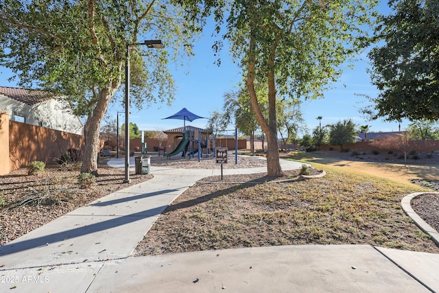 view of yard with playground community and fence