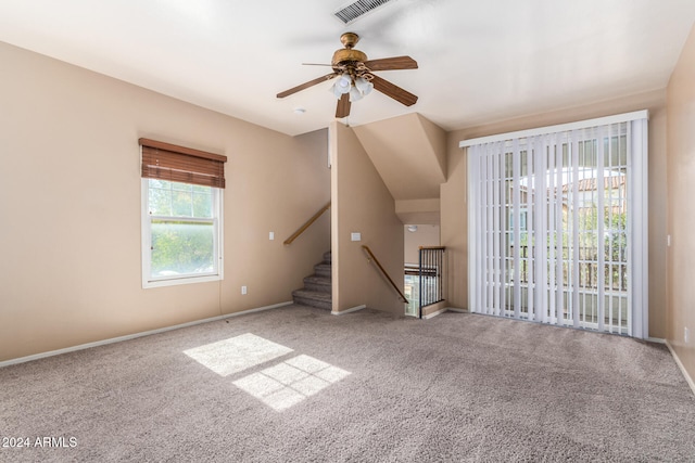 unfurnished living room with carpet and ceiling fan