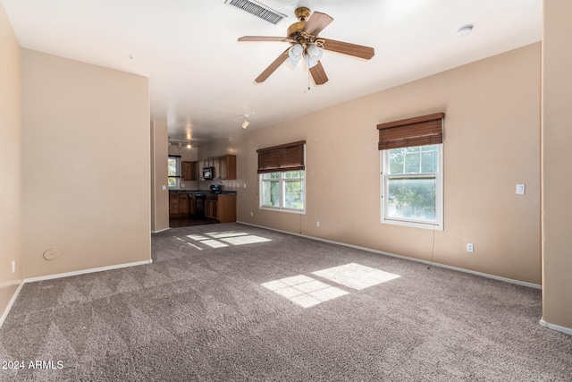 unfurnished living room with carpet floors and ceiling fan