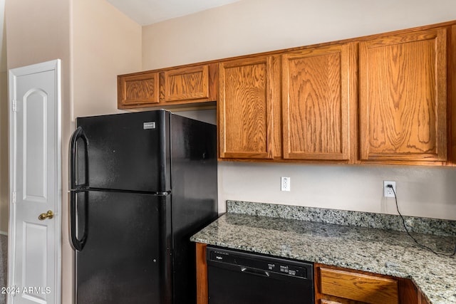 kitchen with black appliances and light stone counters