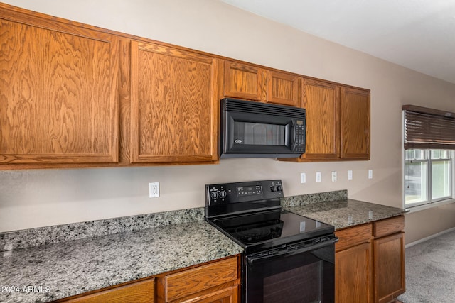 kitchen featuring black appliances, carpet flooring, and stone counters