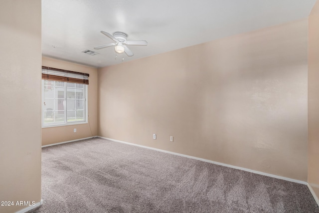 spare room with carpet flooring and ceiling fan