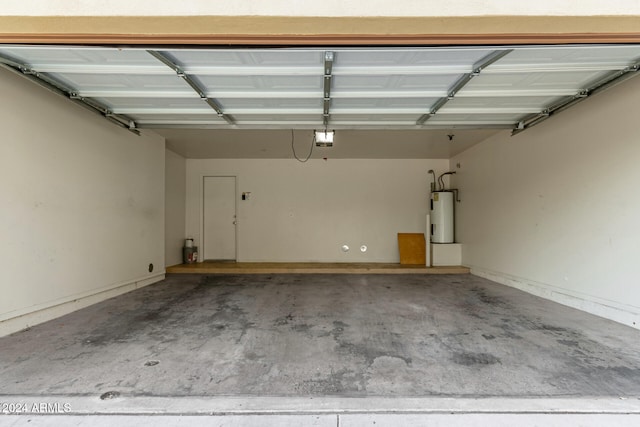 garage with a garage door opener and water heater