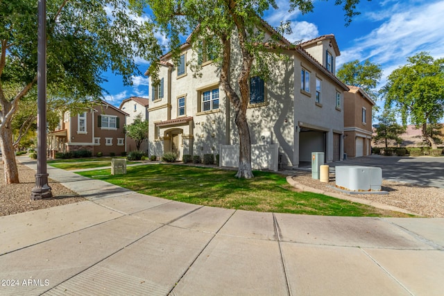 view of front of house featuring a garage and a front lawn