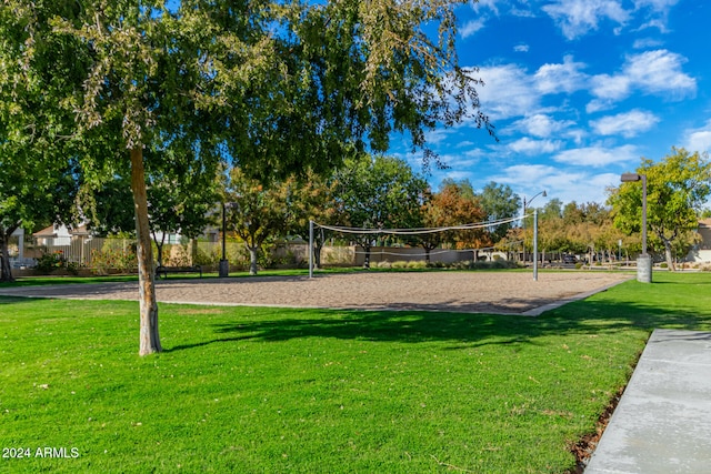 surrounding community featuring volleyball court and a lawn