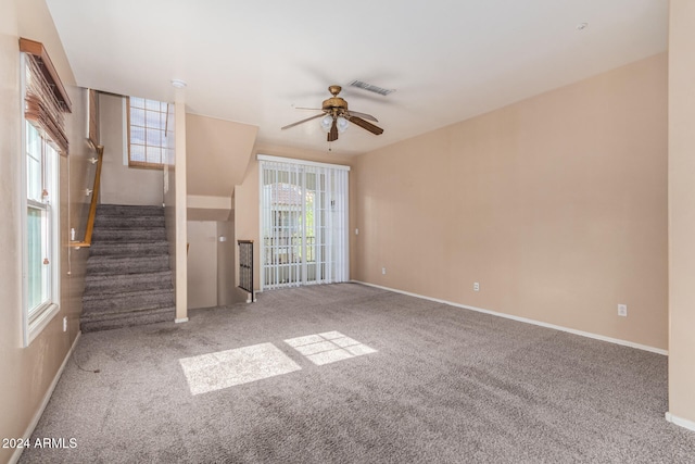 unfurnished living room featuring ceiling fan, a healthy amount of sunlight, and carpet floors