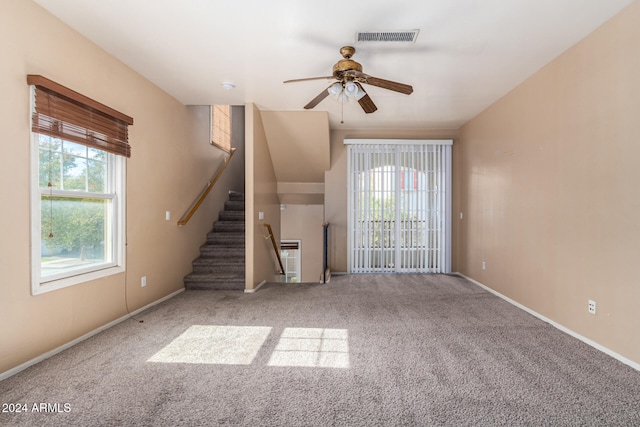 unfurnished living room with carpet and ceiling fan