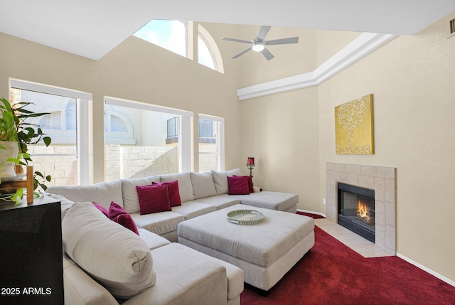 living room featuring plenty of natural light, a towering ceiling, light colored carpet, and a fireplace