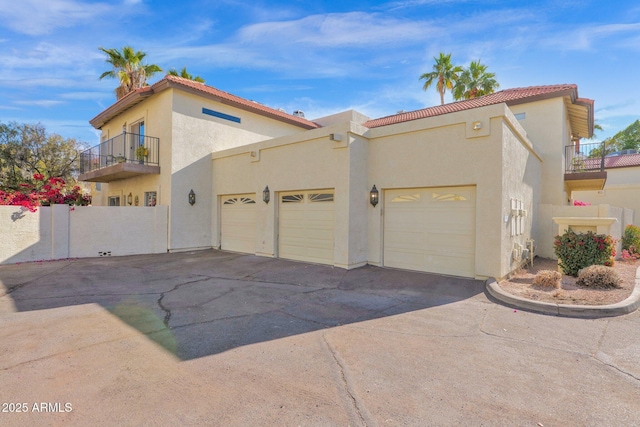 view of side of home with a balcony and a garage