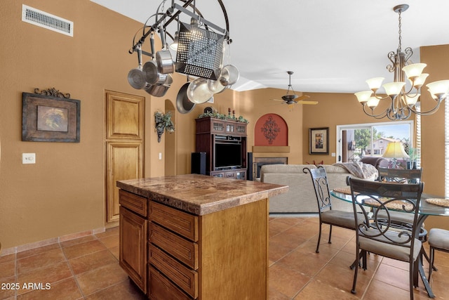 1558 W Maplewood St, Chandler, AZ 85286 - kitchen featuring a chandelier, ceiling fan, a center island, lofted ceiling, and light tile patterned floors