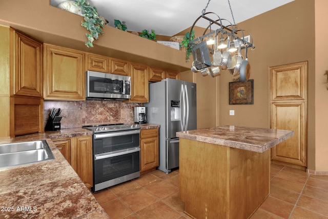 1558 W Maplewood St, Chandler, AZ 85286 - kitchen featuring stainless steel appliances, a center island, backsplash, light tile patterned flooring, and a chandelier