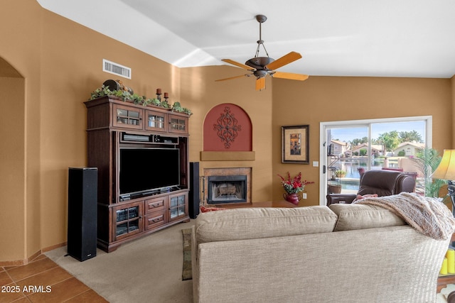 1558 W Maplewood St, Chandler, AZ 85286 - tiled living room with a fireplace, ceiling fan, and vaulted ceiling