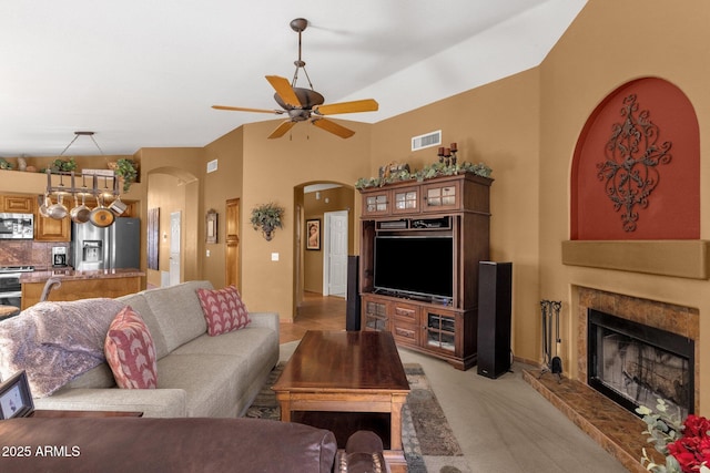 1558 W Maplewood St, Chandler, AZ 85286 - living area featuring arched walkways, a ceiling fan, a high end fireplace, and light carpet