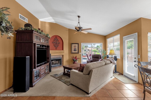 1558 W Maplewood St, Chandler, AZ 85286 - living room with lofted ceiling, a fireplace, ceiling fan, and light tile patterned flooring