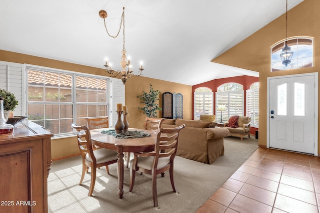 1558 W Maplewood St, Chandler, AZ 85286 - dining space featuring a chandelier, vaulted ceiling, light tile patterned floors, and baseboards