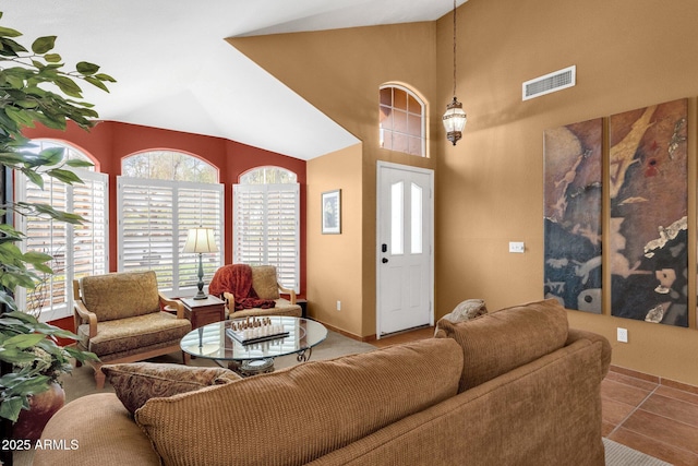 1558 W Maplewood St, Chandler, AZ 85286 - tiled living area featuring vaulted ceiling, healthy amount of natural light, and baseboards