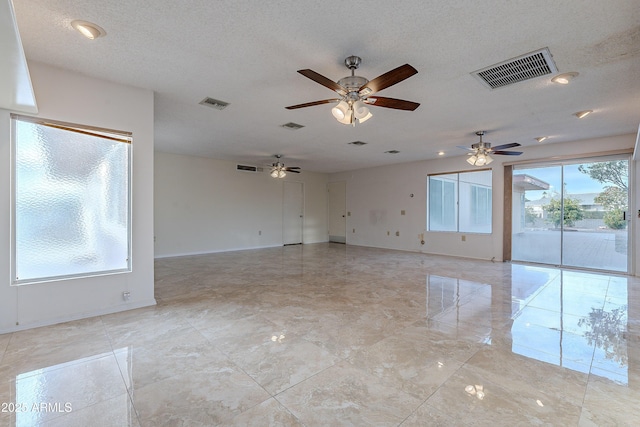 empty room featuring a textured ceiling and ceiling fan