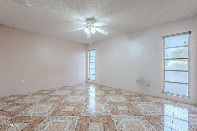 spare room featuring ceiling fan and a textured ceiling