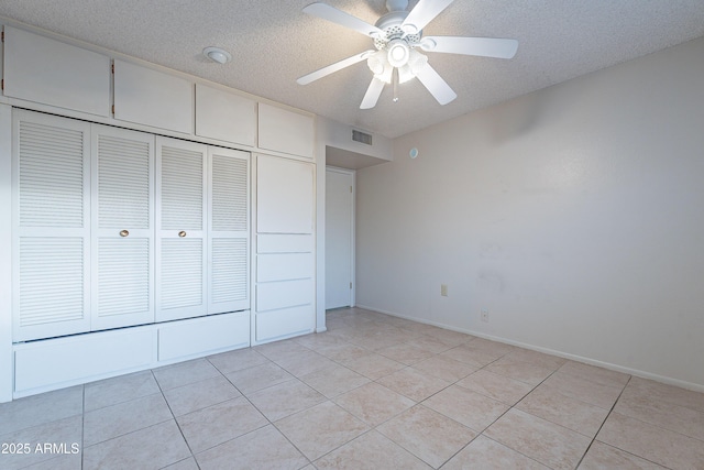 unfurnished bedroom featuring ceiling fan, a closet, and a textured ceiling