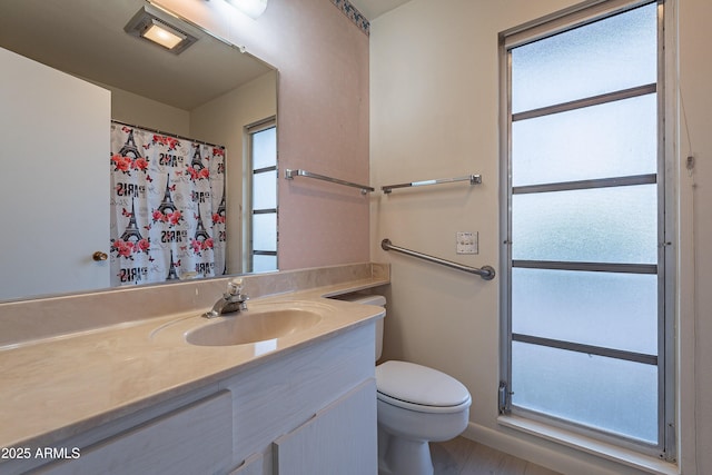 bathroom featuring vanity and toilet