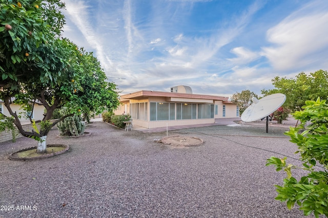 view of front of property featuring a patio area and a sunroom