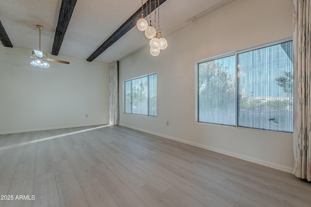 empty room with vaulted ceiling with beams, ceiling fan with notable chandelier, a textured ceiling, and light hardwood / wood-style flooring