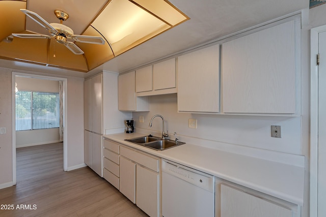 kitchen with ceiling fan, sink, white dishwasher, white cabinets, and light wood-type flooring