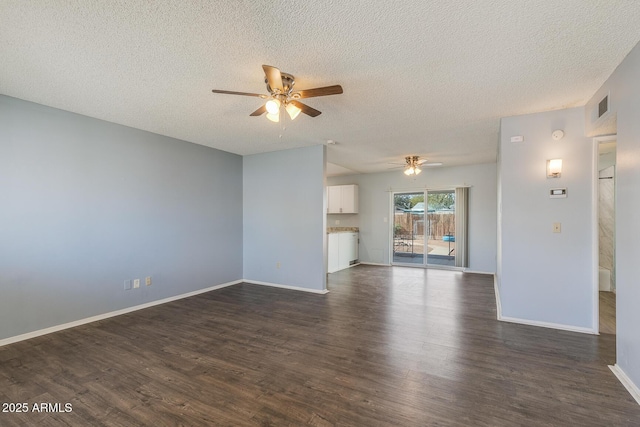 unfurnished living room with dark wood-style floors, visible vents, ceiling fan, a textured ceiling, and baseboards